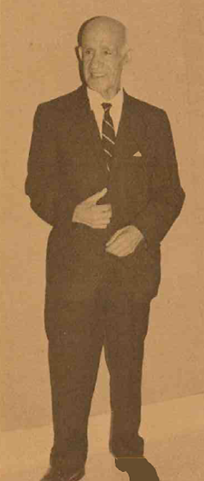 Rudolph Vargas standing in a suit